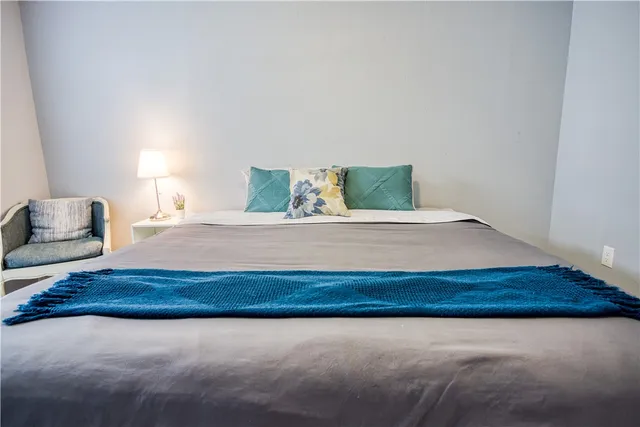 a bedroom with a bed and lamp