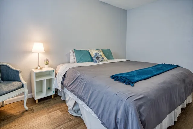 a bedroom with a bed and a lamp