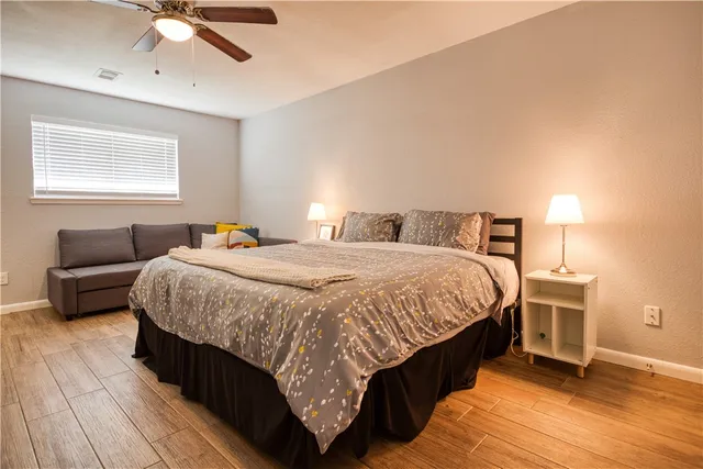 a bedroom with a bed and wooden floor