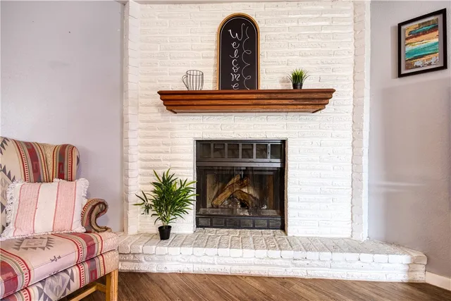 a view of living room with furniture and a fireplace