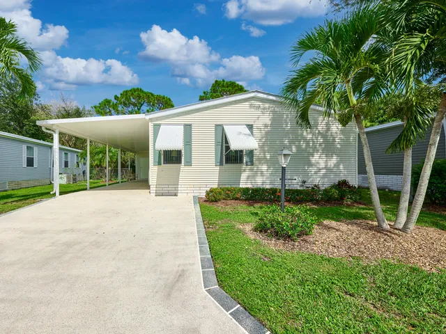 a view of a house with backyard and a porch