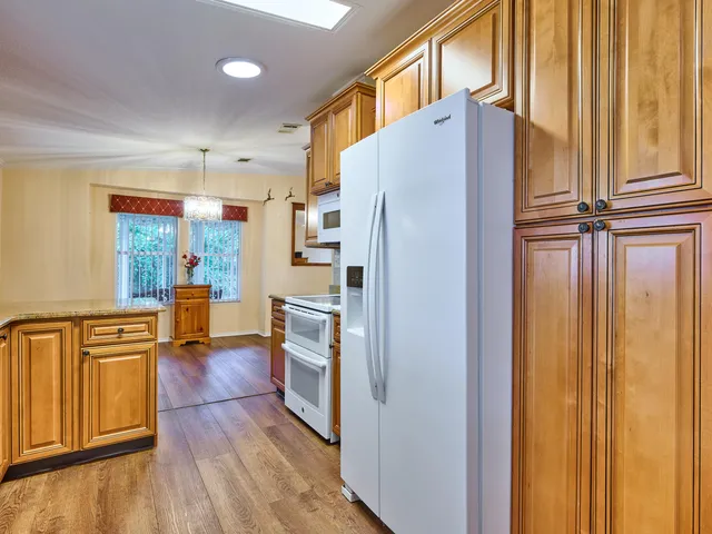 a kitchen with stainless steel appliances granite countertop a sink stove and cabinets