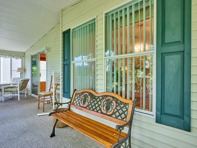 a bedroom with a large bed and chandelier
