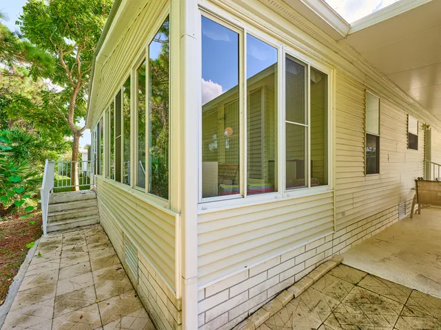 a view of an house with backyard space and balcony