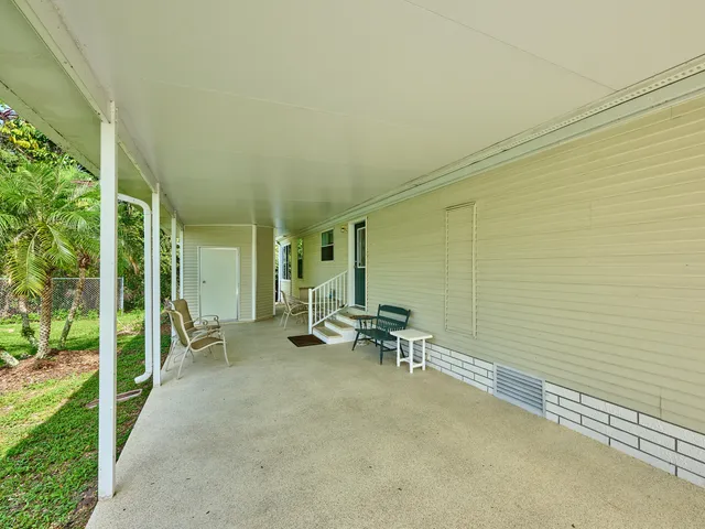 a view of a chair and tables in the balcony