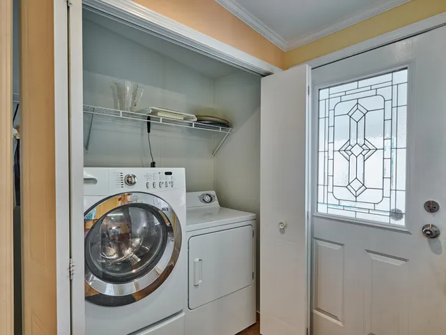 a kitchen with stainless steel appliances a refrigerator and wooden floor