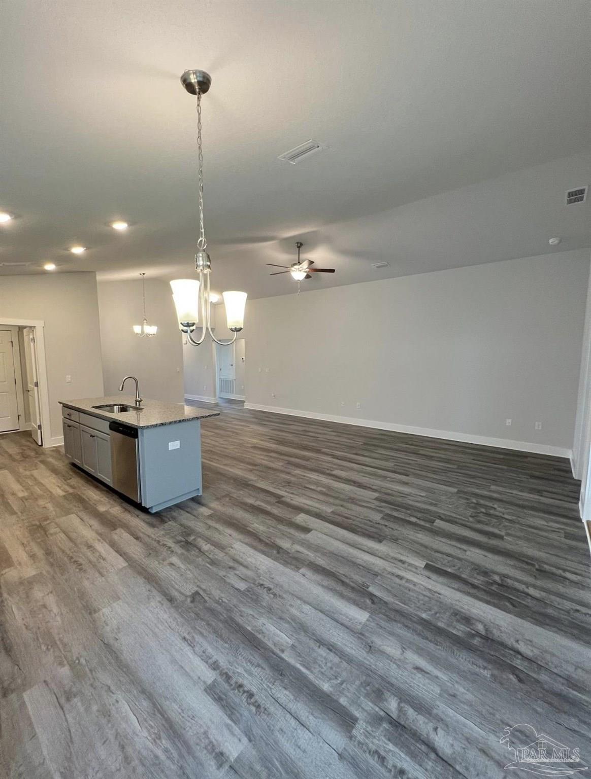 1766 Leigh Loop, Unit 3D Cantonment, FL 32533 - Photo 4 of 8 a view of a room with wooden floor and kitchen view