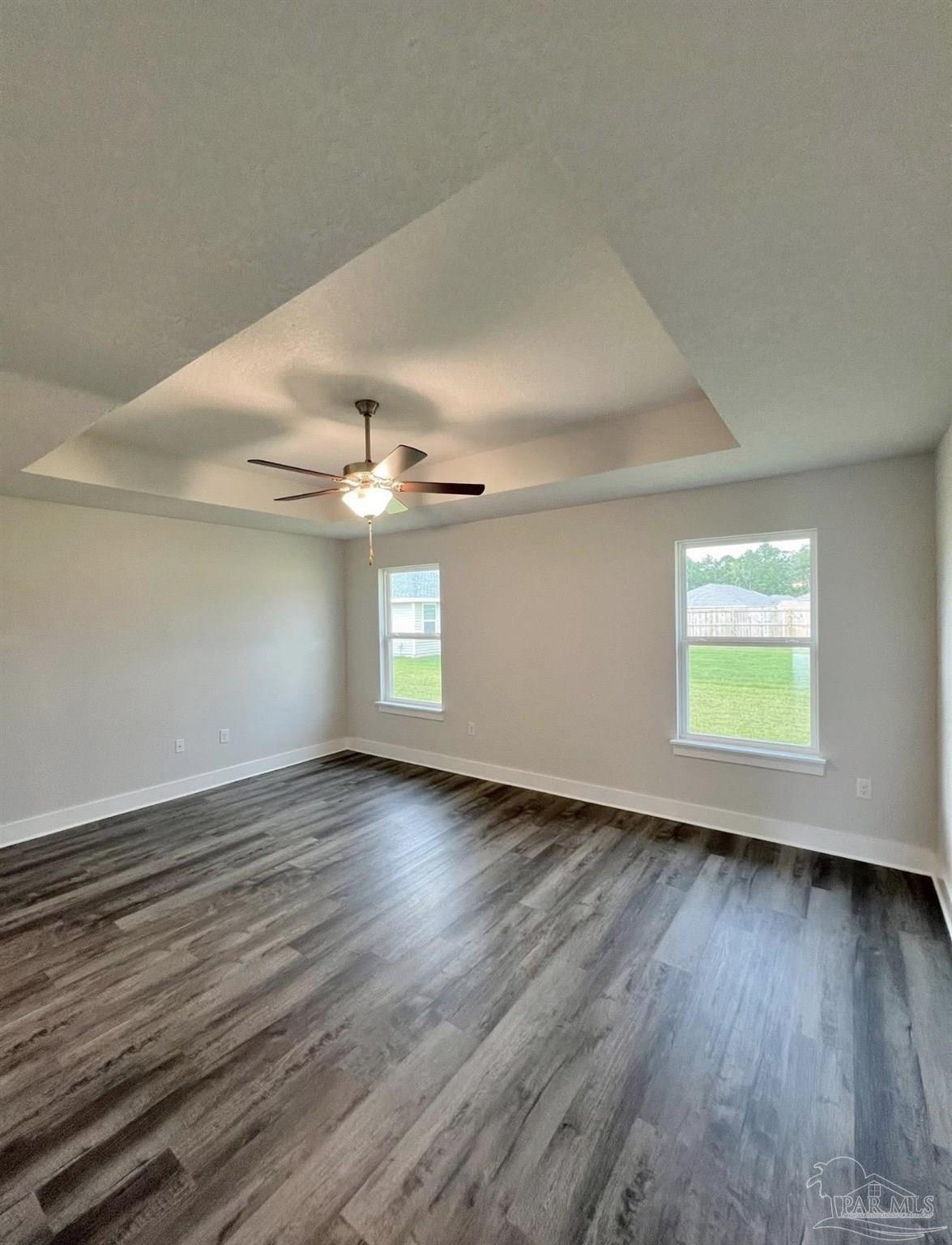 1766 Leigh Loop, Unit 3D Cantonment, FL 32533 - Photo 5 of 8 wooden floor in an empty room with a window