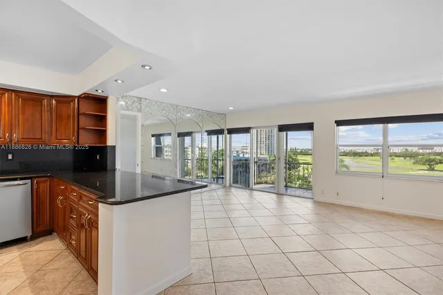 a kitchen with granite countertop a sink and a stove