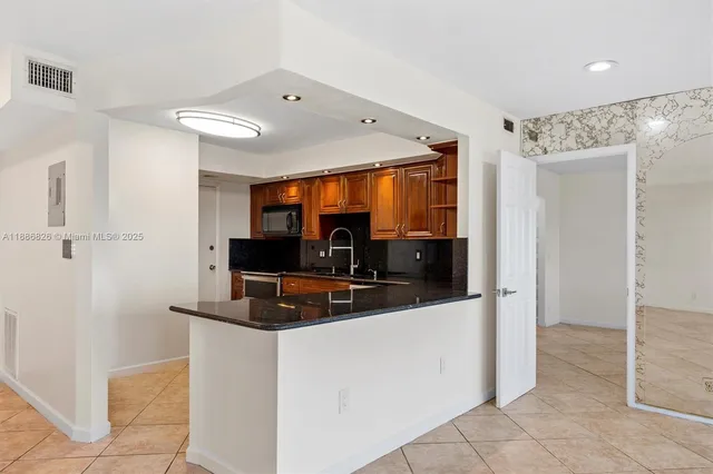 a kitchen with stainless steel appliances a sink and a refrigerator