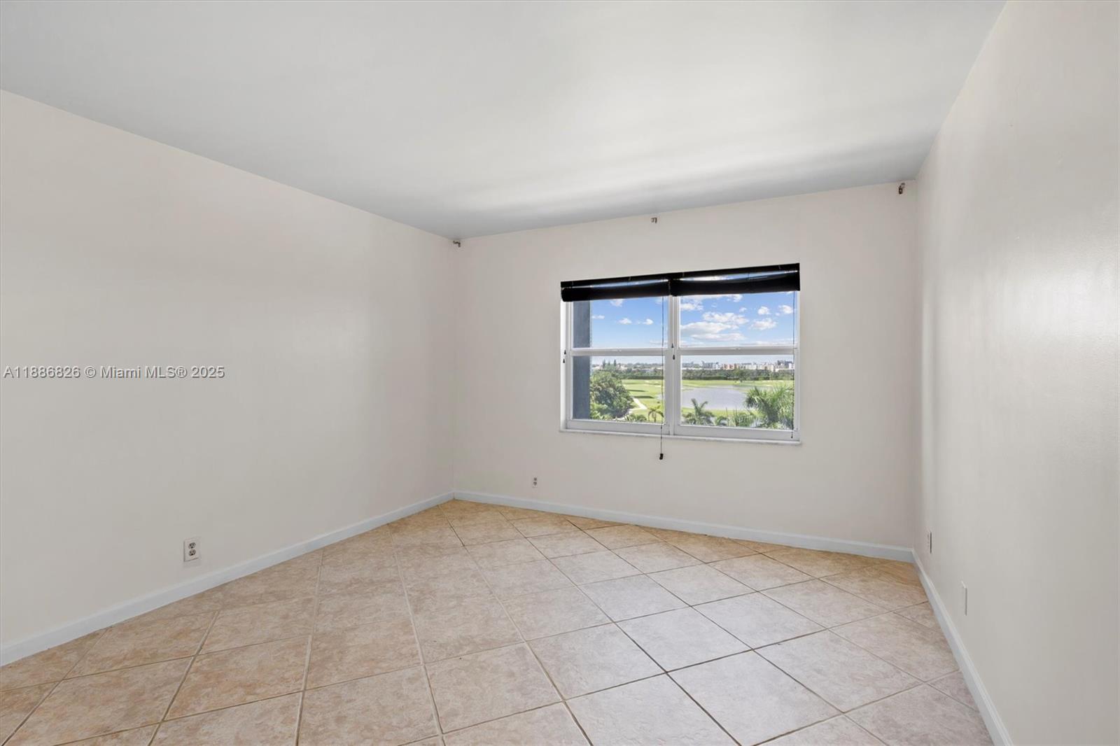200 Diplomat Parkway, Unit 825 Hallandale Beach, FL 33009 - Photo 18 of 29 an empty room with a window