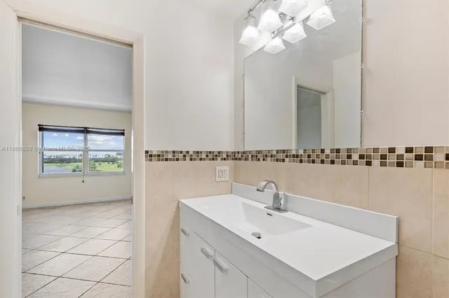 a bathroom with a sink a mirror and a shower