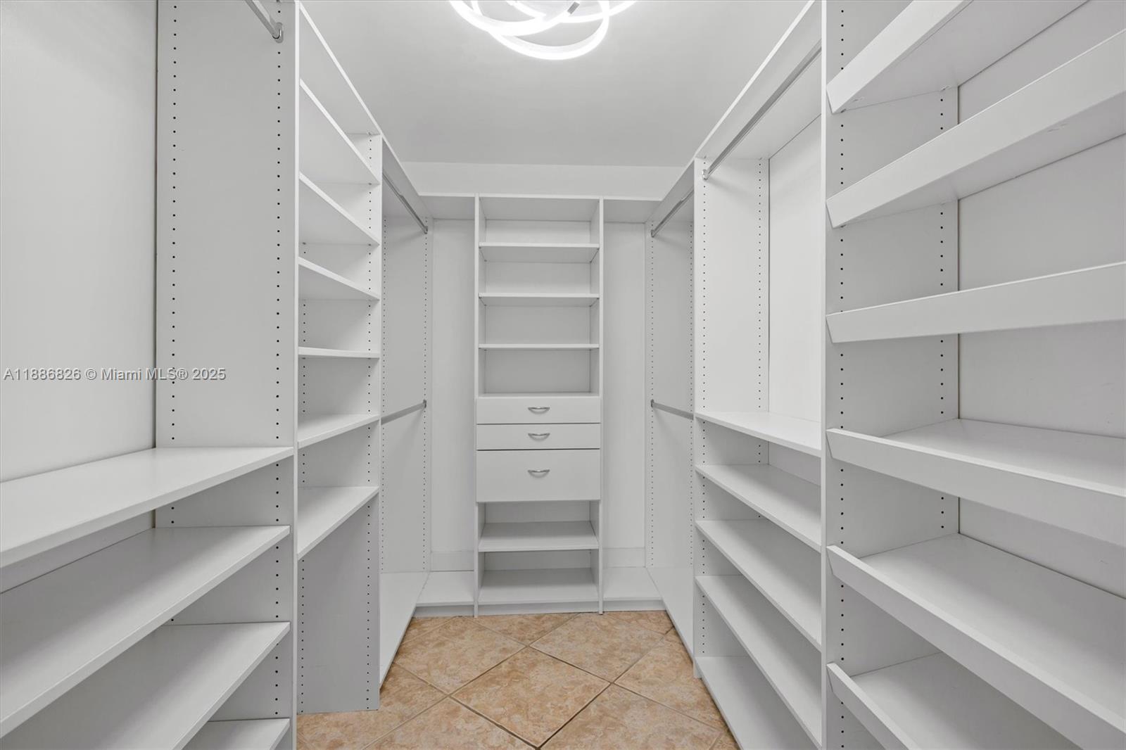 200 Diplomat Parkway, Unit 825 Hallandale Beach, FL 33009 - Photo 21 of 29 a view of walk in closet with empty racks