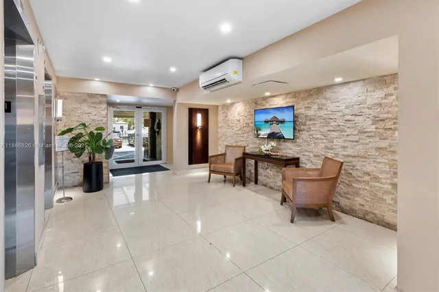 a lobby with furniture and a potted plant