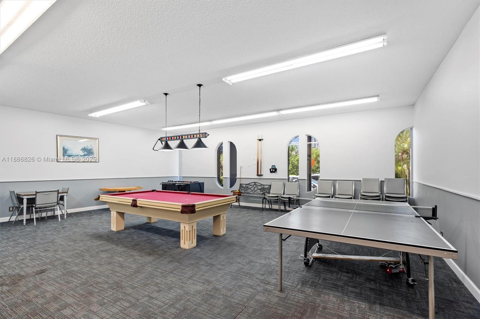 200 Diplomat Parkway, Unit 825 Hallandale Beach, FL 33009 - Photo 29 of 29 a living room with furniture a table and chairs