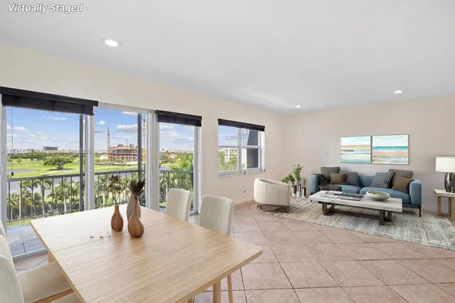 a living room with furniture and large windows