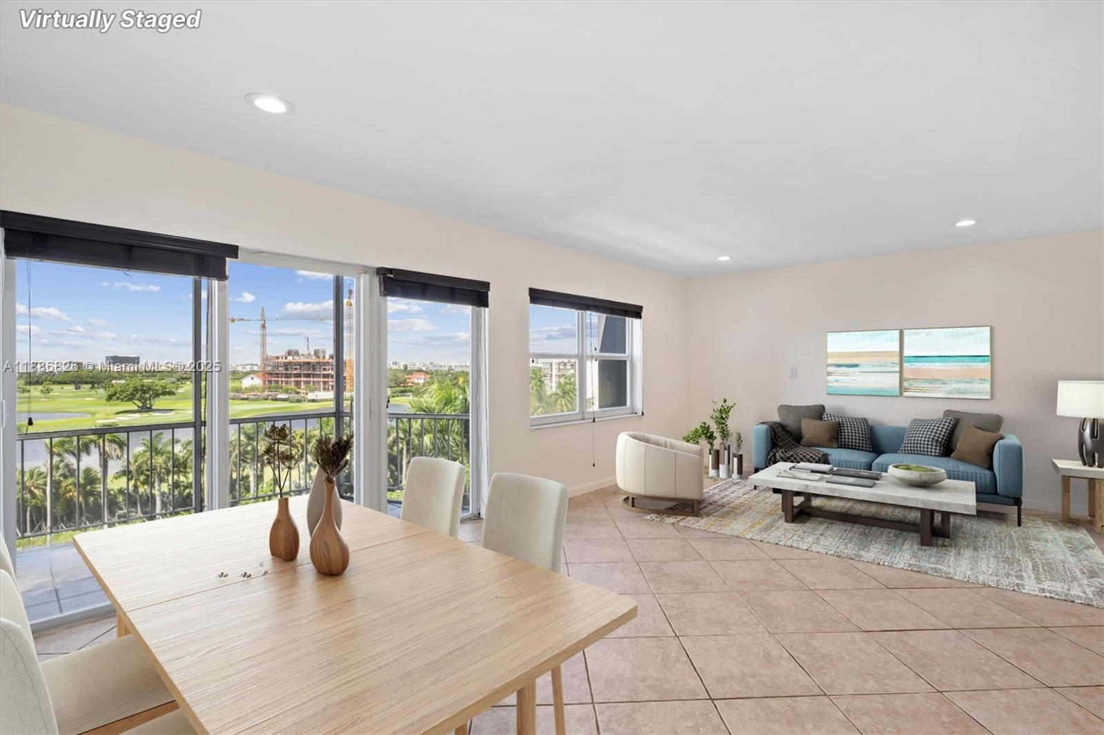 200 Diplomat Parkway, Unit 825 Hallandale Beach, FL 33009 - Photo 3 of 29 a living room with furniture and large windows