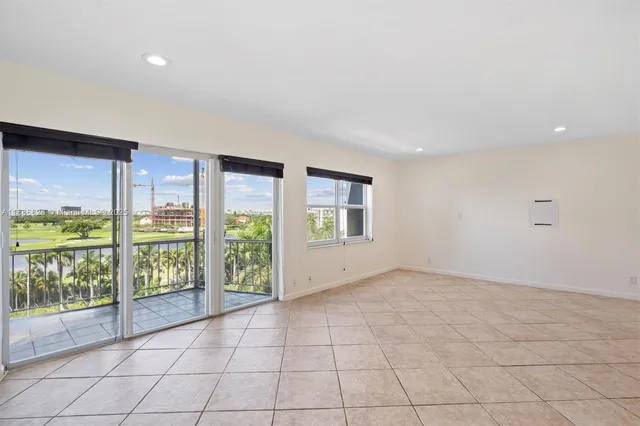 en empty room with sliding door and mountain view