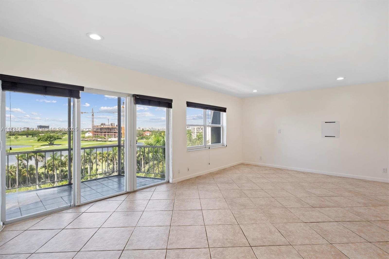 200 Diplomat Parkway, Unit 825 Hallandale Beach, FL 33009 - Photo 4 of 29 en empty room with sliding door and mountain view