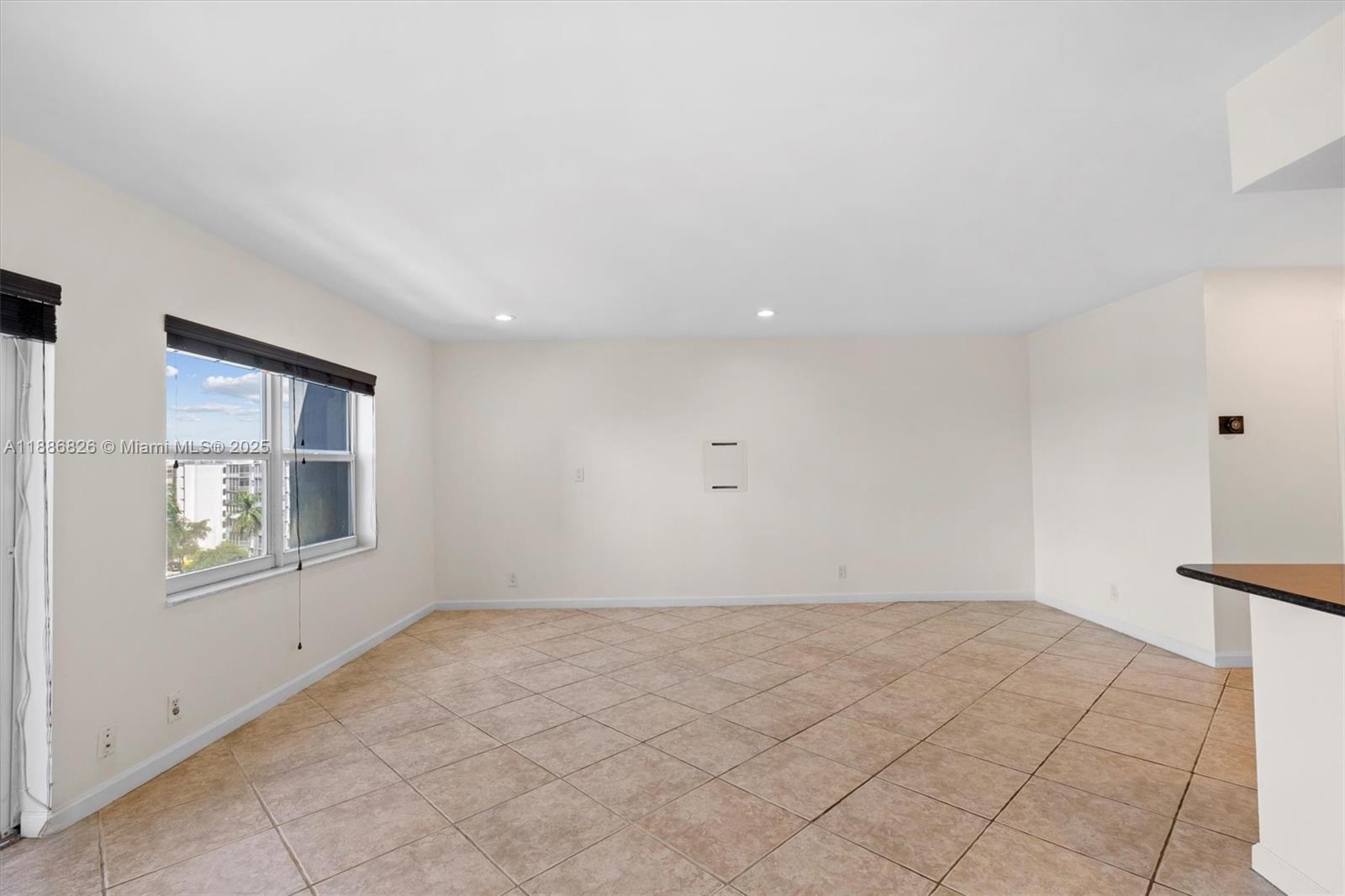 200 Diplomat Parkway, Unit 825 Hallandale Beach, FL 33009 - Photo 8 of 29 an empty room with windows