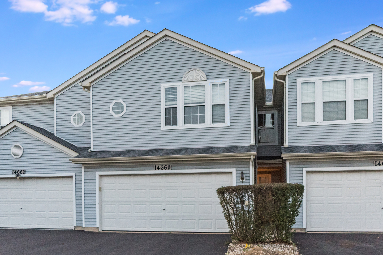 a front view of a house with a garage