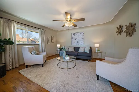 a living room with furniture potted plant and a chandelier
