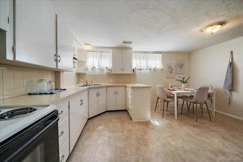 a kitchen with a sink stove and white cabinets