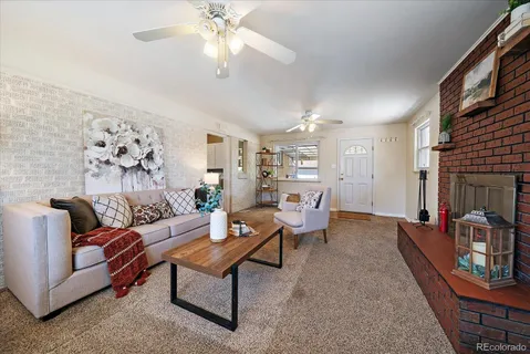 a living room with furniture and a chandelier