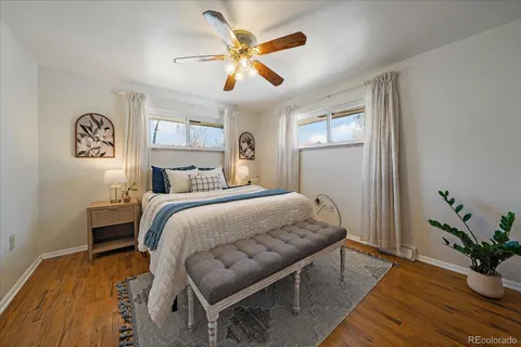 a bedroom with a bed and a potted plant on dresser
