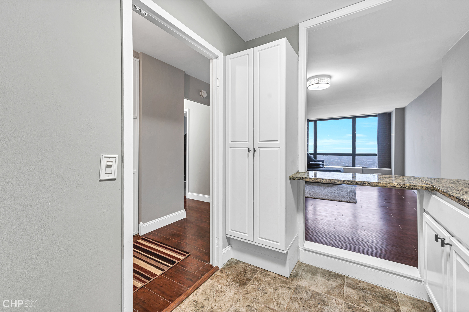 5415 North Sheridan Road, Unit 5409 Chicago, IL 60640 - Photo 11 of 37 a view of a hallway with wooden floor and livingroom
