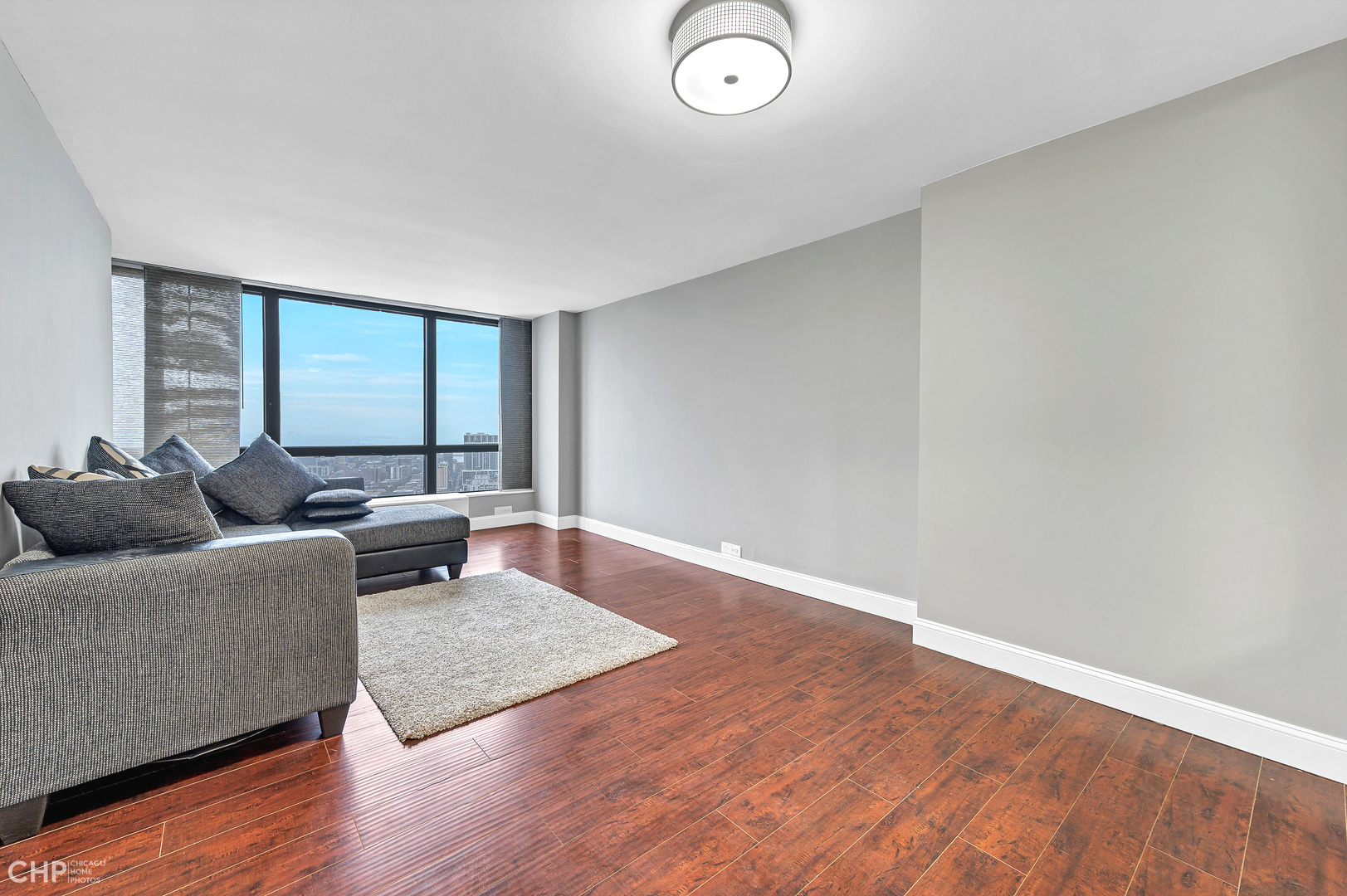 5415 North Sheridan Road, Unit 5409 Chicago, IL 60640 - Photo 5 of 37 a living room with furniture and a large window