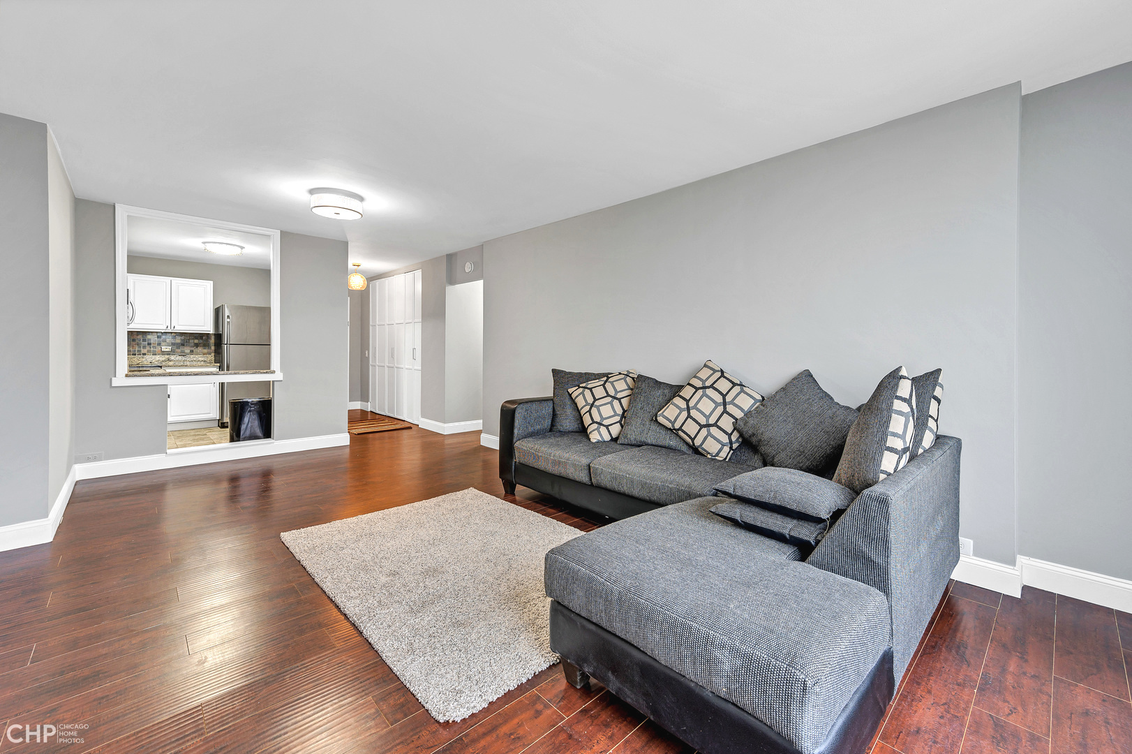 5415 North Sheridan Road, Unit 5409 Chicago, IL 60640 - Photo 9 of 37 a living room with furniture and a wooden floor