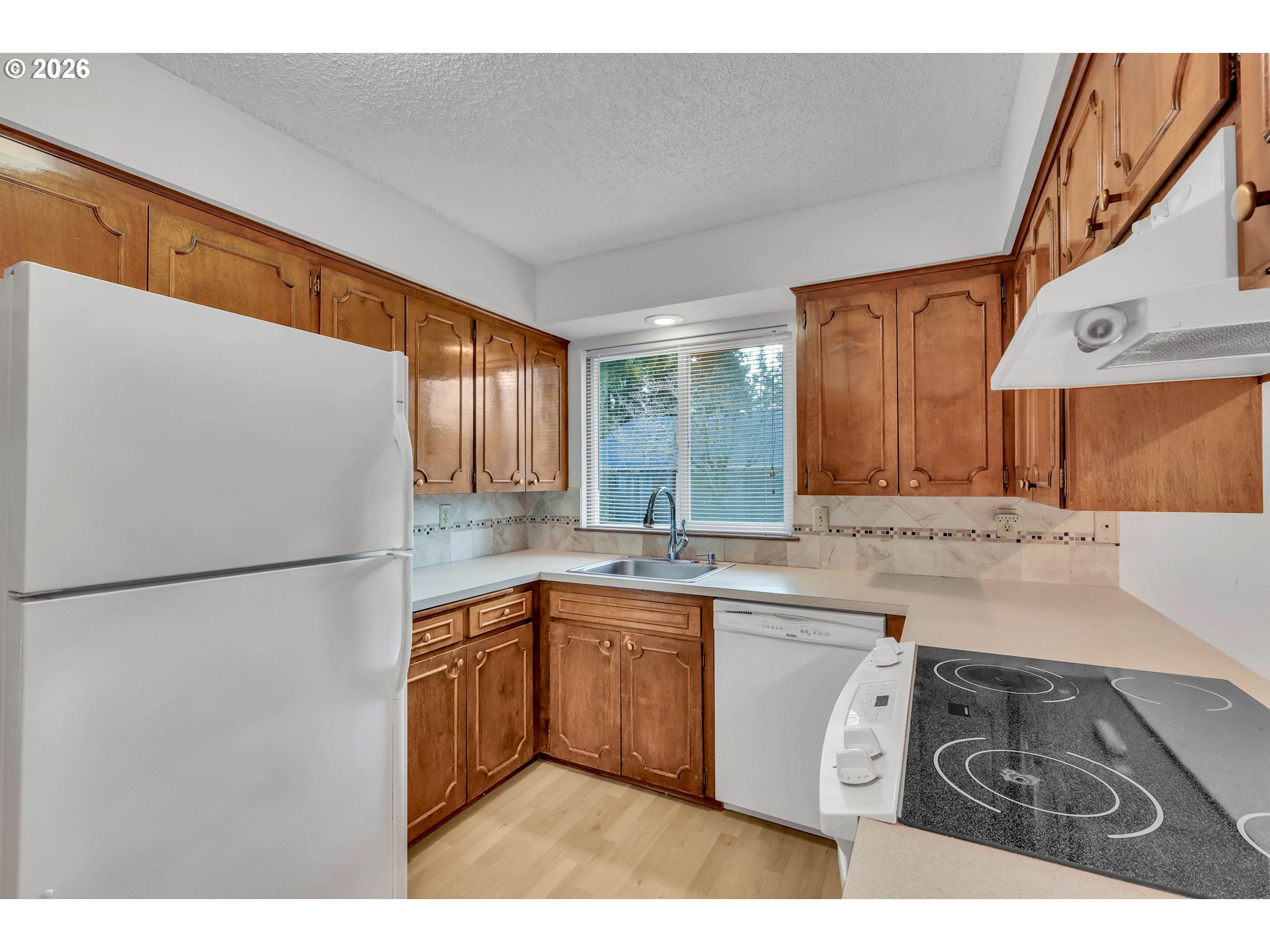 6980 Southwest 130th Avenue Beaverton, OR 97008 - Photo 18 of 38 a kitchen with a sink a stove a refrigerator and a microwave