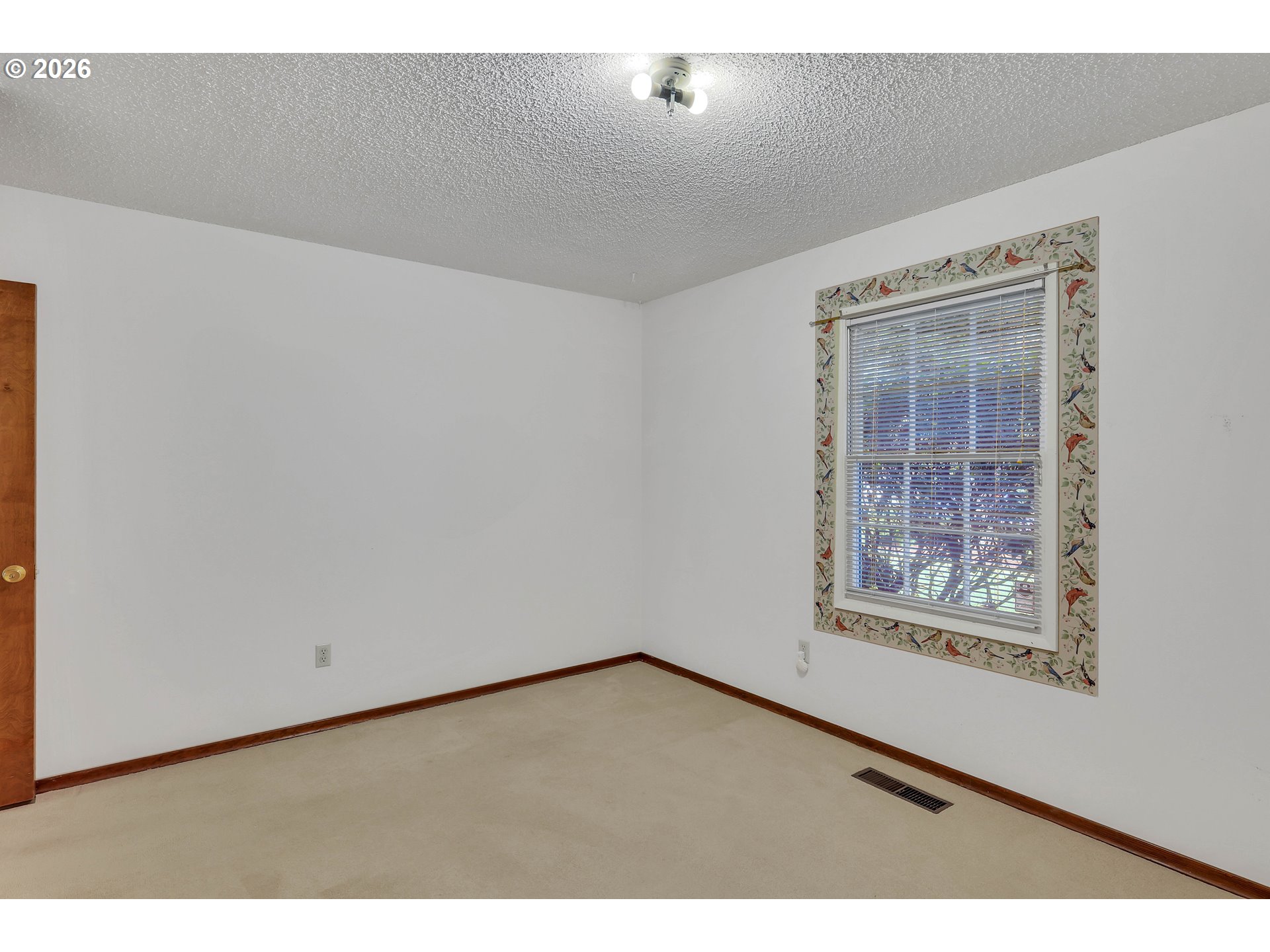 6980 Southwest 130th Avenue Beaverton, OR 97008 - Photo 25 of 38 a view of an empty room with wooden floor and a window