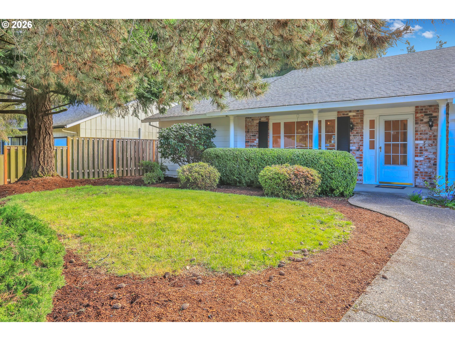6980 Southwest 130th Avenue Beaverton, OR 97008 - Photo 3 of 38 a front view of a house with a garden and yard