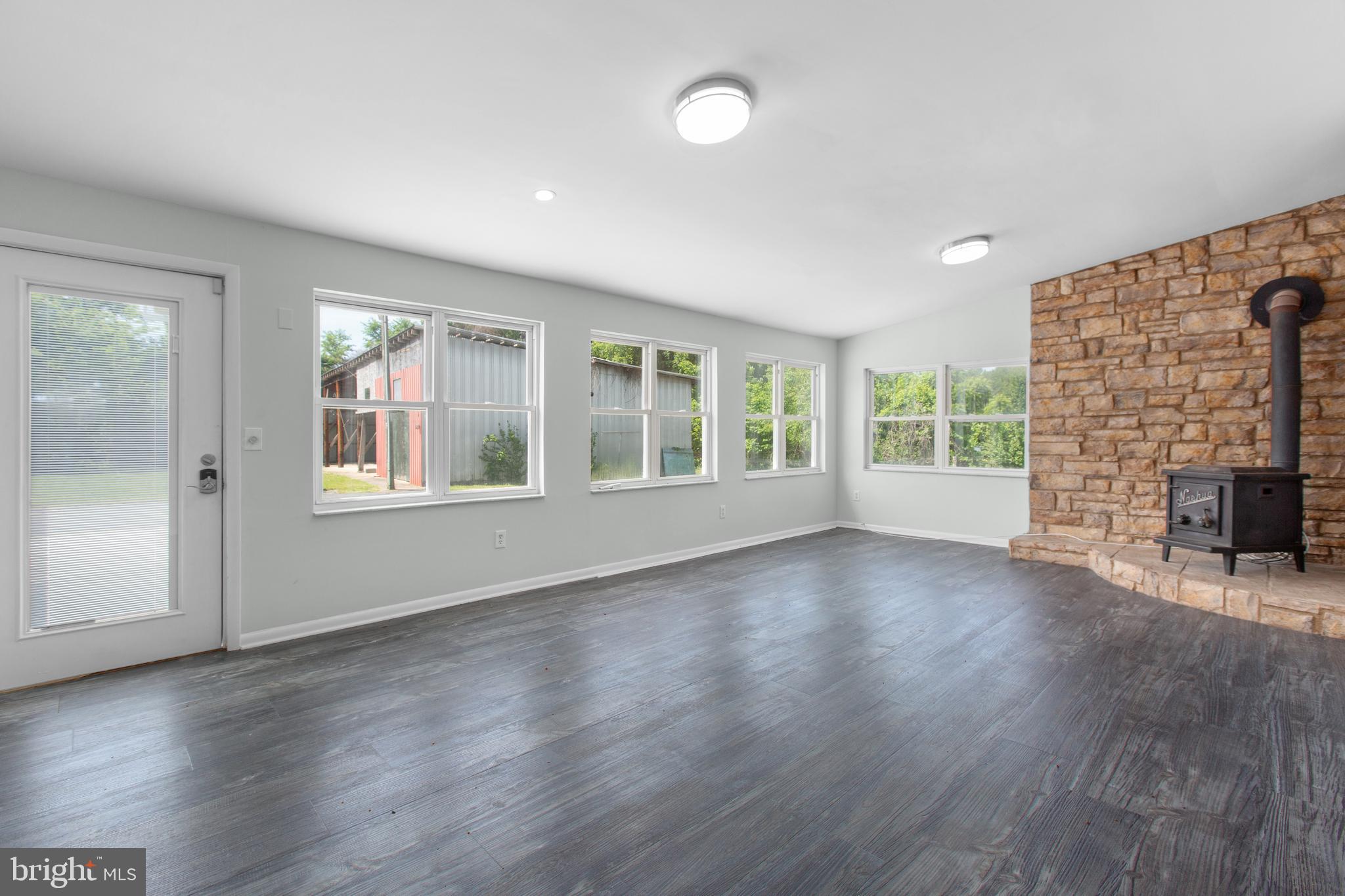 10827 Catharpin Road Spotsylvania, VA 22553 - Photo 11 of 39 an empty room with wooden floor and windows