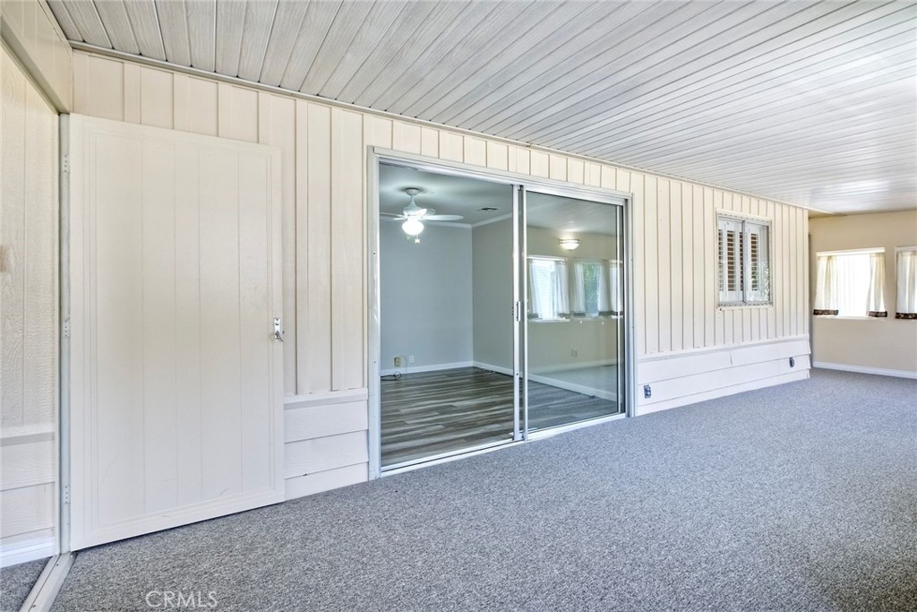 4747 Oak Crest Road, Unit 28 Fallbrook, CA 92028 - Photo 19 of 29 an empty room with sliding door and wooden floor