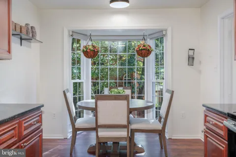 a view of a dining room with furniture large windows and wooden floor