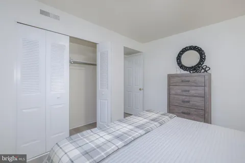 a bedroom with a bed and a dresser