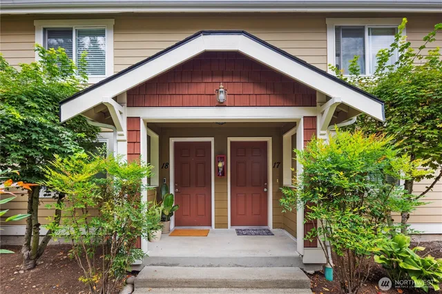 a front view of a house with plants