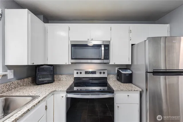 a kitchen with a stove microwave and refrigerator