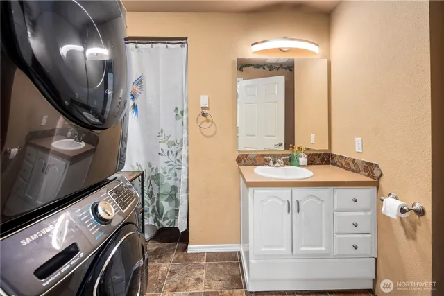 a bathroom with a mirror sink and toilet