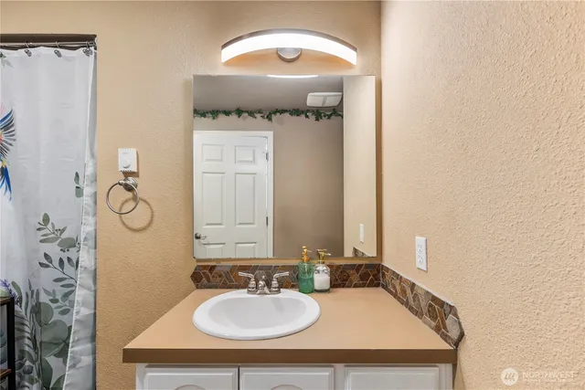 a bathroom with a sink and a mirror