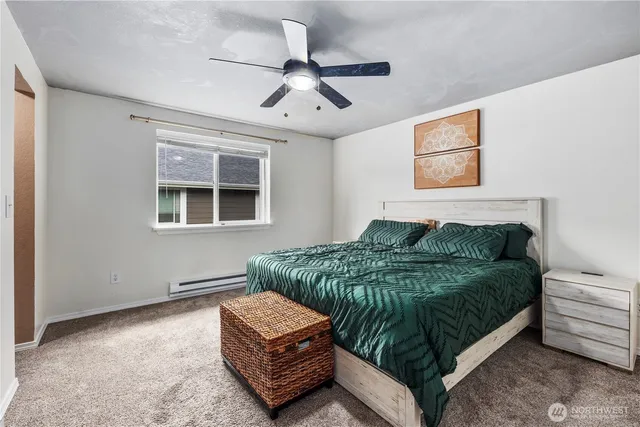 a bedroom with a bed couch and window