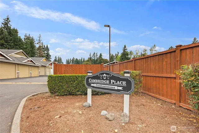 a view of a street with wooden fence