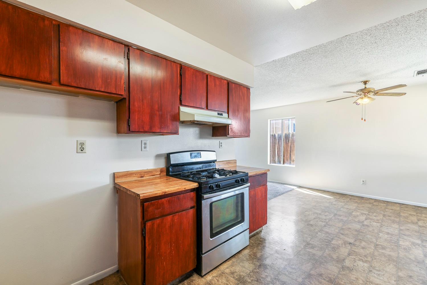 180 Monroe Street Coalinga, CA 93210 - Photo 15 of 25 a kitchen with stainless steel appliances granite countertop a stove a sink and a microwave