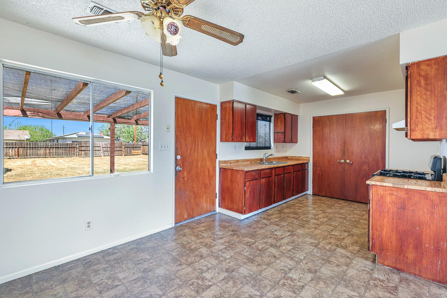 180 Monroe Street Coalinga, CA 93210 - Photo 20 of 25 a kitchen with stainless steel appliances granite countertop a stove a sink and a refrigerator
