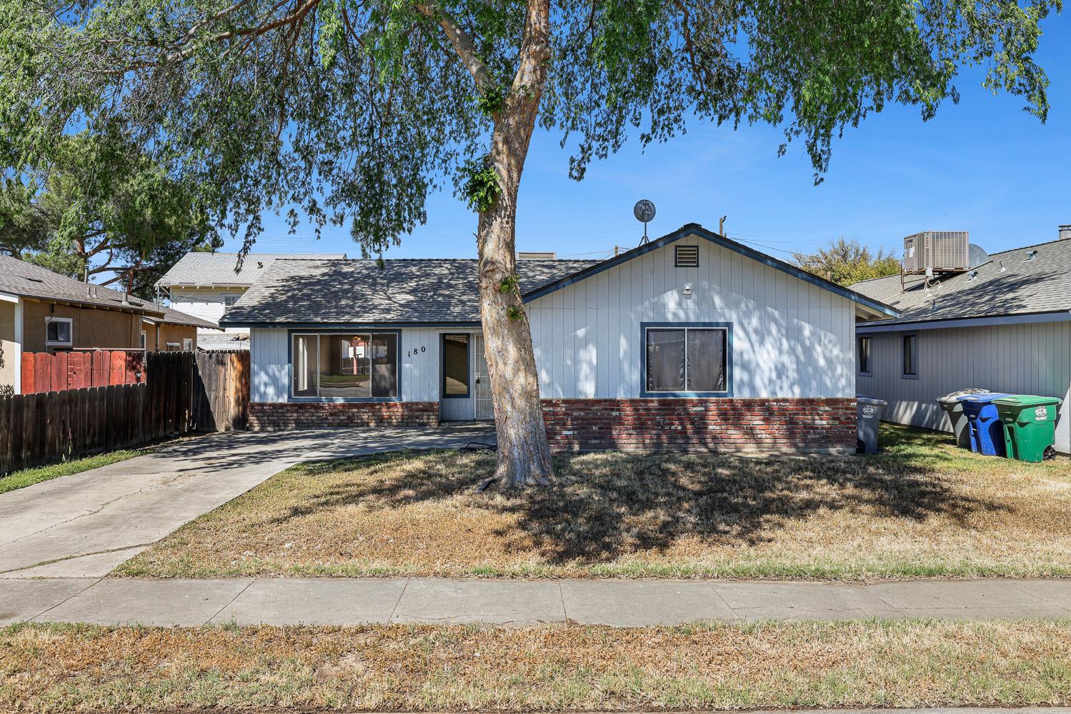 180 Monroe Street Coalinga, CA 93210 - Photo 2 of 25 a front view of a house with garden
