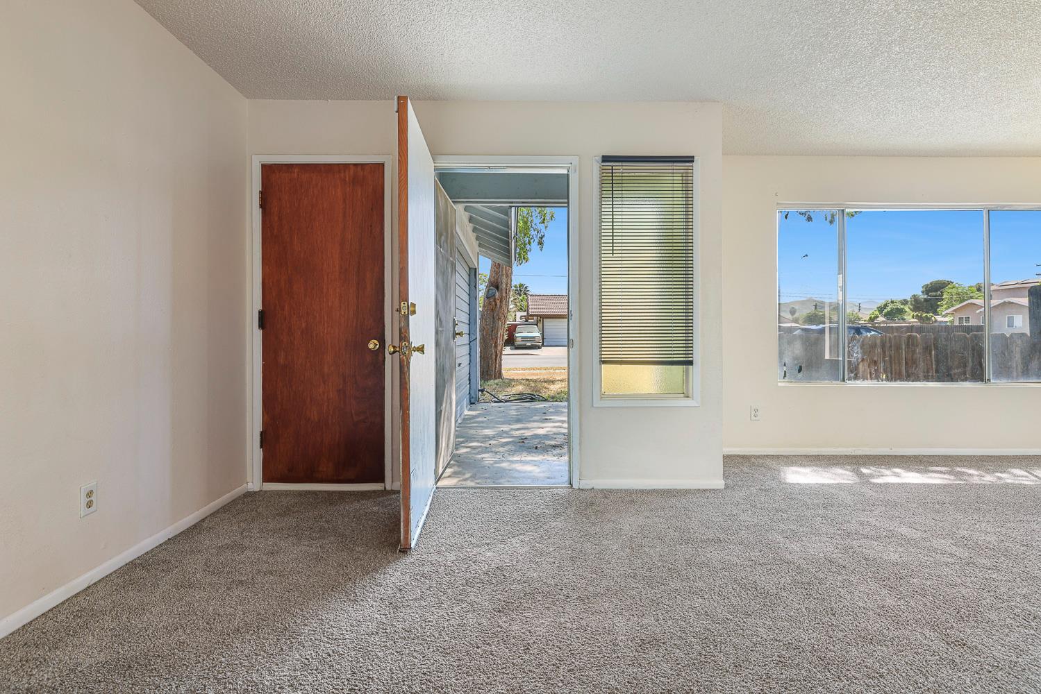 180 Monroe Street Coalinga, CA 93210 - Photo 6 of 25 a view of a big room with closet and windows