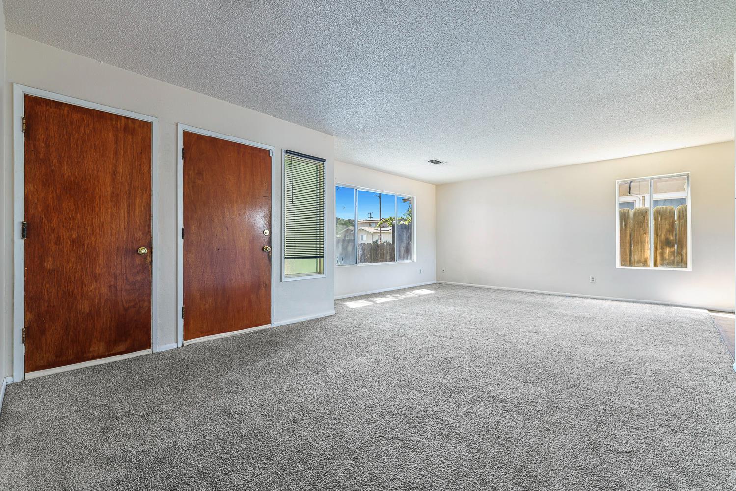 180 Monroe Street Coalinga, CA 93210 - Photo 9 of 25 a view of an empty room with a window